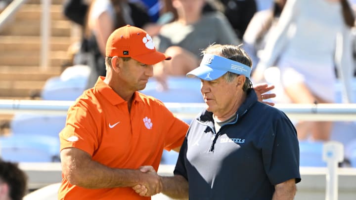 Oct 4, 2025; Chapel Hill, North Carolina, USA; Clemson Tigers head coach Dabo Swinney with North Carolina Tar Heels head coach Bill Belichick before the game at Kenan Stadium. Mandatory Credit: Bob Donnan-Imagn Images