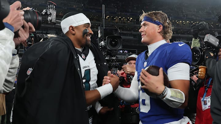 Oct 9, 2025; East Rutherford, New Jersey, USA; Philadelphia Eagles quarterback Jalen Hurts (1) and New York Giants quarterback Jaxson Dart (6) shake hands after the game at MetLife Stadium.  
