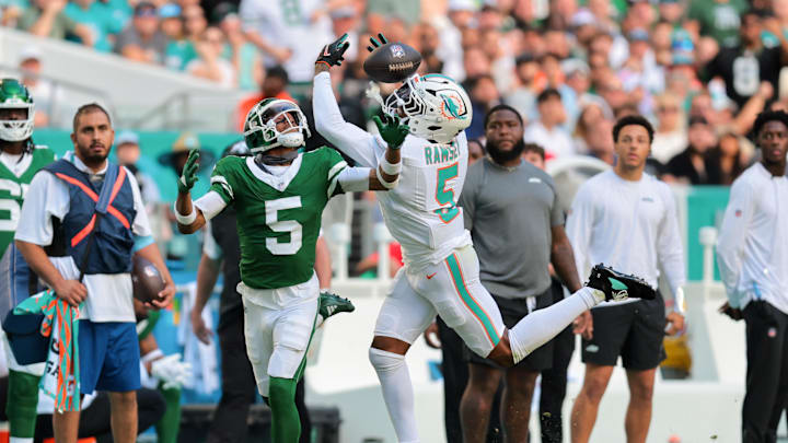 Dec 8, 2024; Miami Gardens, Florida, USA; Miami Dolphins cornerback Jalen Ramsey (5) breaks a pass intended to New York Jets wide receiver Garrett Wilson (5) during the third quarter at Hard Rock Stadium. Mandatory Credit: Sam Navarro-Imagn Images