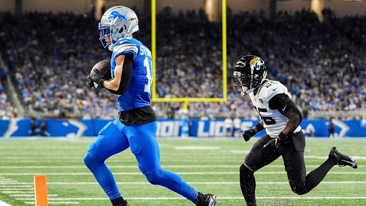Detroit Lions wide receiver Amon-Ra St. Brown (14) makes a catch in the end zone for a touchdown against Jacksonville Jaguars cornerback Ronald Darby (25) during the second half at Ford Field in Detroit on Sunday, Nov. 17, 2024.