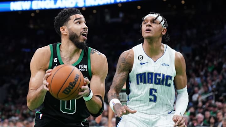 Dec 16, 2022; Boston, Massachusetts, USA; Boston Celtics forward Jayson Tatum (0) looks for an opening against Orlando Magic forward Paolo Banchero (5) in the second half at TD Garden. Mandatory Credit: David Butler II-Imagn Images