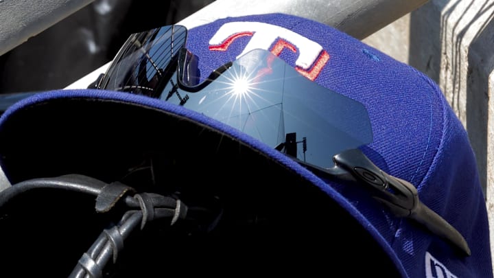 May 29, 2023; Detroit, Michigan, USA;  Texas Rangers cap in glove sits in dugout during the eighth inning against the Detroit Tigers at Comerica Park. Mandatory Credit: Rick Osentoski-Imagn Images