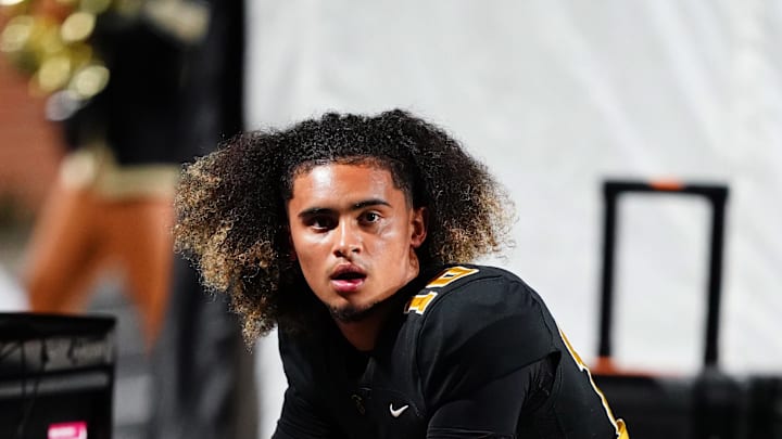 Oct 20, 2023; Carrollton, GA, USA; Carrollton Trojans quarterback Julian Lewis (10) watches on from the sidelines against the Westlake Lions during the first half at Grisham Stadium. The 15-year-old Carrollton High student has already committed to playing for the University of Southern California Trojans and has been considered one of the top high school quarterback prospects. Mandatory Credit: John David Mercer-Imagn Images