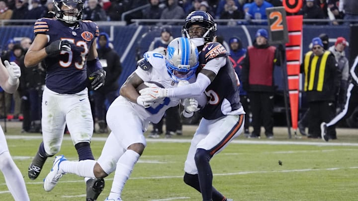 Jan 4, 2026; Chicago, Illinois, USA; Detroit Lions running back Jahmyr Gibbs (0) scores a touchdown against Chicago Bears cornerback Nahshon Wright (26) during the first half at Soldier Field. Mandatory Credit: David Banks-Imagn Images