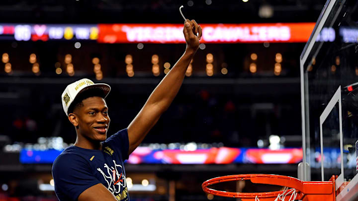 Apr 8, 2019; Minneapolis, MN, USA; Virginia Cavaliers guard De'Andre Hunter (12) cuts down the net after beating the Texas Tech Red Raiders in the championship game of the 2019 men's Final Four at US Bank Stadium. Mandatory Credit: Bob Donnan-Imagn Images