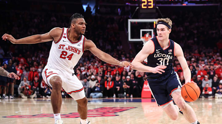 Feb 23, 2025; New York, New York, USA; Connecticut Huskies forward Liam McNeeley (30) drives past St. John's Red Storm forward Zuby Ejiofor (24) in the first half at Madison Square Garden. Mandatory Credit: Wendell Cruz-Imagn Images Feb 23, 2025; New York, New York, USA; Connecticut Huskies forward Liam McNeeley (30) drives past St. John's Red Storm forward Zuby Ejiofor (24) in the first half at Madison Square Garden. Mandatory Credit: Wendell Cruz-Imagn Images