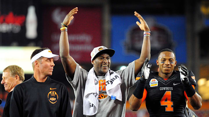 Jan 2, 2012; Glendale, AZ, USA; Oklahoma State Cowboys cornerback Justin Gilbert (right) celebrates with wide receiver Justin Blackmon (center) and head coach Mike Gundy after the 2012 Fiesta Bowl against the Stanford Cardinal at University of Phoenix Stadium. The Cowboys won 41-38 in overtime. Mandatory Credit: Mark J. Rebilas-Imagn Images