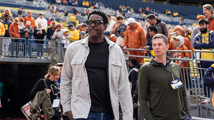 Michigan basketball legend Chris Webber walks out of the tunnel to watch warm up before Texas game at Michigan Stadium in Ann Arbor on Saturday, September 7, 2024.