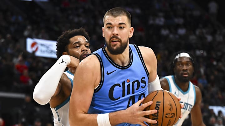 Mar 16, 2025; Inglewood, California, USA; LA Clippers center Ivica Zubac (40) moves the ball against Charlotte Hornets forward Miles Bridges (0) during the second half at Intuit Dome. Mandatory Credit: Jonathan Hui-Imagn Images