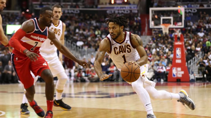 Nov 3, 2017; Washington, DC, USA; Cleveland Cavaliers guard Derrick Rose (1) dribbles the ball as Washington Wizards guard John Wall (2) defends in the third quarter at Capital One Arena. The Cavaliers won 130-122. Mandatory Credit: Geoff Burke-Imagn Images