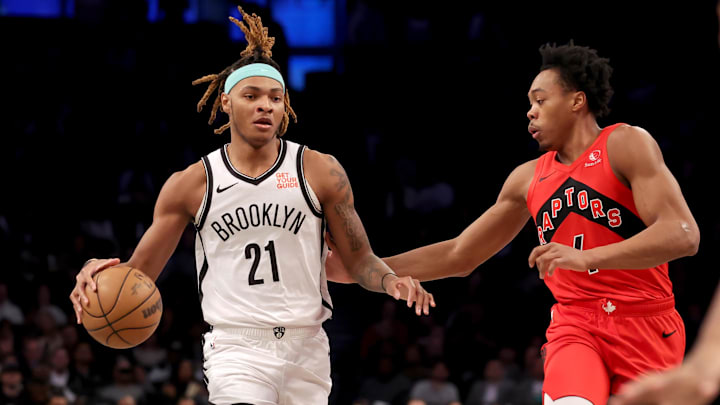 Mar 26, 2025; Brooklyn, New York, USA; Brooklyn Nets forward Noah Clowney (21) brings the ball up court against Toronto Raptors forward Scottie Barnes (4) during the first quarter at Barclays Center. Mandatory Credit: Brad Penner-Imagn Images
