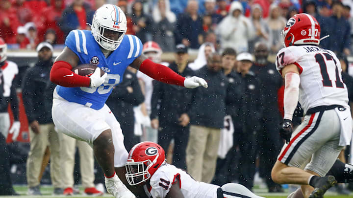 Nov 9, 2024; Oxford, Mississippi, USA; Mississippi Rebels defensive  JJ Pegues (38) runs the ball as Georgia Bulldogs linebacker Jalon Walker (11) makes the tackle during the first half at Vaught-Hemingway Stadium. Mandatory Credit: Petre Thomas-Imagn Images