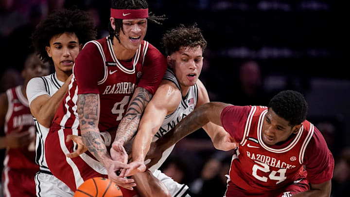 Arkansas forward Trevon Brazile (4) and forward Billy Richmond III (24) fight for the ball with Vanderbilt guard Chris Manon (30) during the first half at Memorial Gym in Nashville, Tenn., Tuesday, March 4, 2025.