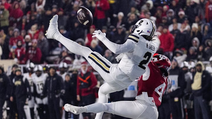 Nov 30, 2024; Bloomington, Indiana, USA;  Purdue Boilermakers defensive back Nyland Green (2) and Indiana Hoosiers wide receiver Myles Price (4) try and catch the ball in the first half at Memorial Stadium. Mandatory Credit: Trevor Ruszkowski-Imagn Images