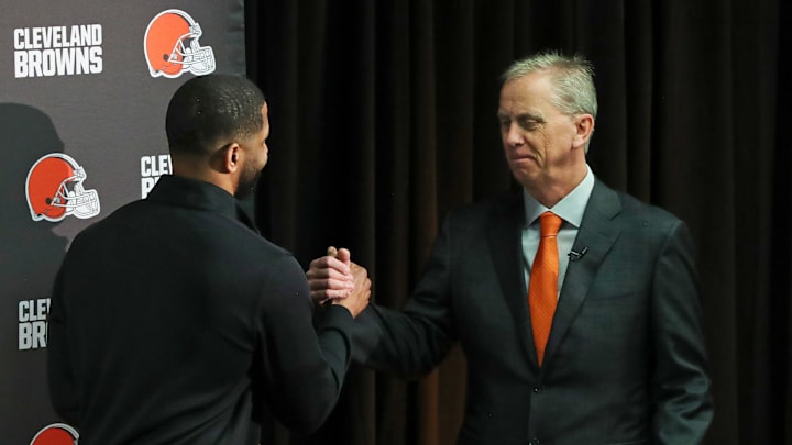 Cleveland Browns coach Todd Monken, facing, shakes hands with general manager Andrew Berry as he takes the podium at his introductory news conference at the team's training facility Feb. 3, 2026, in Berea.