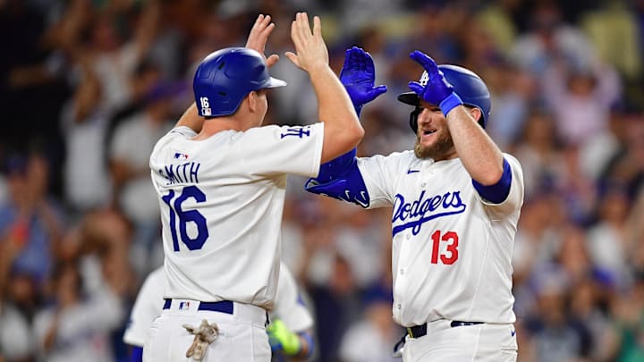 Aug 19, 2024; Los Angeles, California, USA; Los Angeles Dodgers third baseman Max Muncy (13) is greeted by catcher Will Smith (16) after hitting a two run home run against the Seattle Mariners during the seventh inning at Dodger Stadium. Mandatory Credit: Gary A. Vasquez-Imagn Images