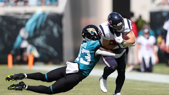 Oct 9, 2022; Jacksonville, Florida, USA;  Houston Texans running back Rex Burkhead (28) is tackled by Jacksonville Jaguars linebacker Devin Lloyd (33) in the second quarter at TIAA Bank Field. Mandatory Credit: Nathan Ray Seebeck-Imagn Images