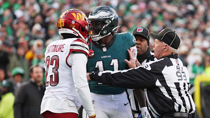 Jan 26, 2025; Philadelphia, PA, USA; Philadelphia Eagles quarterback Jalen Hurts (1) talks with Washington Commanders cornerback Marshon Lattimore (23) as back judge Scott Helverson (93) trie to break them up during the first half in the NFC Championship game at Lincoln Financial Field. Mandatory Credit: Bill Streicher-Imagn Images