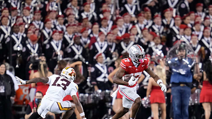 Ohio State Buckeyes wide receiver Carnell Tate (17) catches a pass in front of Minnesota Golden Gophers defensive back Mike Gerald (13) during the first half of the NCAA football game at Ohio Stadium in Columbus on Oct. 4, 2025.