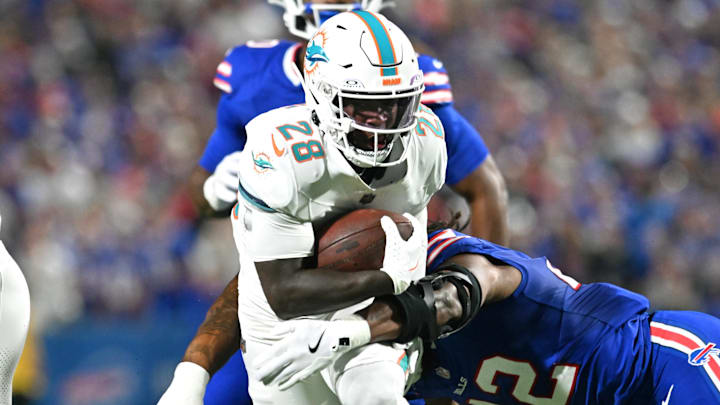 Miami Dolphins running back De'von Achane (28) runs against Buffalo Bills linebacker Dorian Williams (42) in the first quarter at Highmark Stadium. Miami Dolphins running back De'von Achane (28) runs against Buffalo Bills linebacker Dorian Williams (42) in the first quarter at Highmark Stadium.