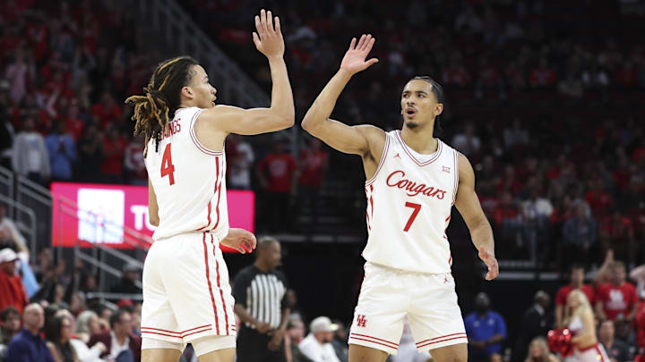 Dec 6, 2025; Houston, TX, USA; Houston Cougars guard Milos Uzan (7) celebraetes with guard Kingston Flemings (4) after a play during the second half against the Florida State Seminoles at Toyota Center. 