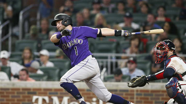 Colorado Rockies center fielder Garrett Hampson (1) hits a single against the Atlanta Braves in the fifth inning at Truist Park in 2022.