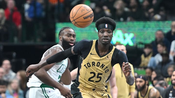Nov 17, 2023; Toronto, Ontario, CAN;  Toronto Raptors forward Chris Boucher (25) pursues a loose ball ahead of Boston Celtics guard Jaylen Brown (7) in the first half at Scotiabank Arena. Mandatory Credit: Dan Hamilton-Imagn Images