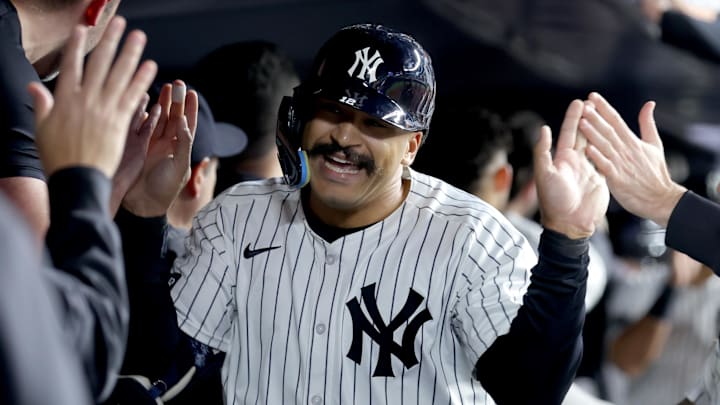 May 7, 2025; Bronx, New York, USA; New York Yankees pinch hitter Trent Grisham (12) celebrates his game tying two run home run against the San Diego Padres with teammates in the dugout during the eighth inning at Yankee Stadium. Mandatory Credit: Brad Penner-Imagn Images