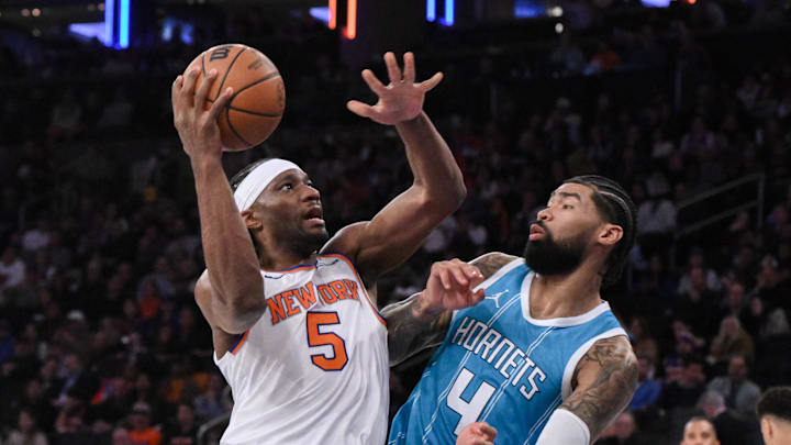 Dec 5, 2024; New York, New York, USA; New York Knicks forward Precious Achiuwa (5) shoots the ball while being defended by Charlotte Hornets center Nick Richards (4) during the second half at Madison Square Garden. Mandatory Credit: John Jones-Imagn Images