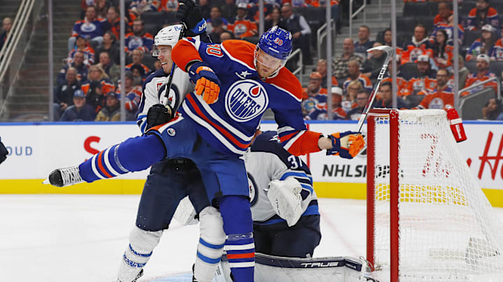 Oct 9, 2024; Edmonton, Alberta, CAN; Edmonton Oilers forward Corey Perry (90) battles with Winnipeg Jets defensemen 