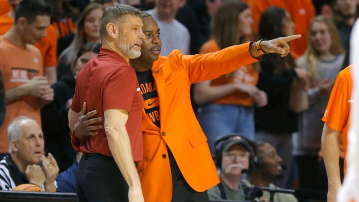 Oklahoma Sooners head coach Porter Moser and Oklahoma State Cowboys head coach Mike Boynton talk before a men's Bedlam college basketball game between the Oklahoma State University Cowboys (OSU) and the University of Oklahoma Sooners (OU) at Gallagher-Iba Arena in Stillwater, Okla., Wednesday, Jan. 18, 2023.