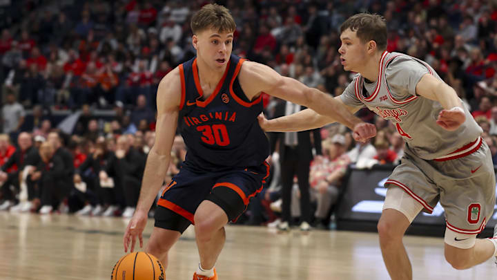 Feb 14, 2026; Nashville, Tennessee, USA; Virginia Cavaliers guard Dallin Hall (30) dribbles the ball past Ohio State Buckeyes guard Gabe Cupps (4) during the second half at Bridgestone Arena. Mandatory Credit: Steve Roberts-Imagn Images Feb 14, 2026; Nashville, Tennessee, USA; Virginia Cavaliers guard Dallin Hall (30) dribbles the ball past Ohio State Buckeyes guard Gabe Cupps (4) during the second half at Bridgestone Arena. Mandatory Credit: Steve Roberts-Imagn Images