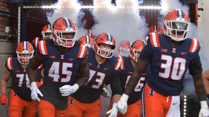 Aug 29, 2025; Champaign, Illinois, USA;  Illinois Fighting Illini players take the field before the start of an NCAA game with the Western Illinois Leathernecks at Memorial Stadium. Mandatory Credit: Ron Johnson-Imagn Images