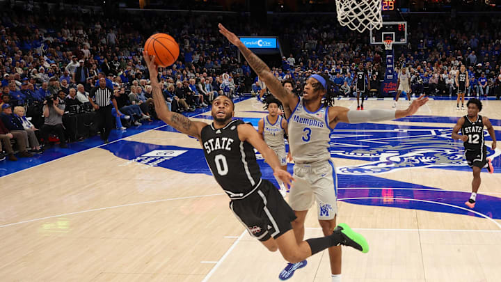 Dec 21, 2024; Memphis, Tennessee, USA; Mississippi State Bulldogs guard Claudell Harris Jr. (0) shoots over Memphis Tigers guard Colby Rogers (3) during the first half  at FedExForum. Mandatory Credit: Wesley Hale-Imagn Images