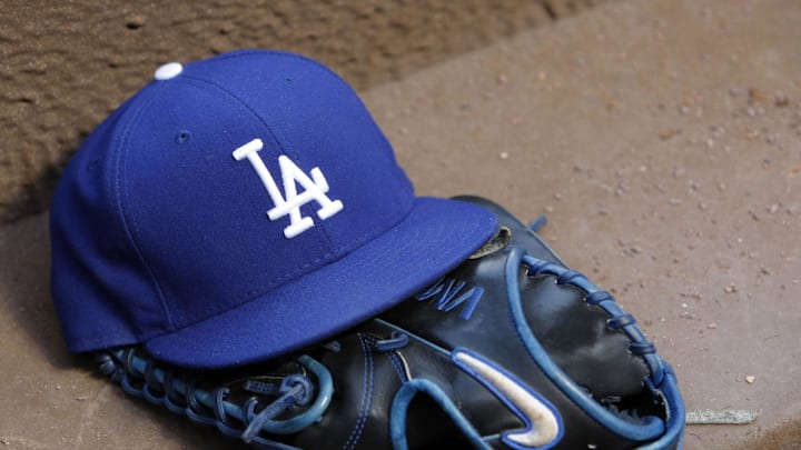 Aug 12, 2014; Atlanta, GA, USA; Detailed view of Los Angeles Dodgers hat and glove in the dugout against the Atlanta Braves in the third inning at Turner Field. Mandatory Credit: Brett Davis-Imagn Images
