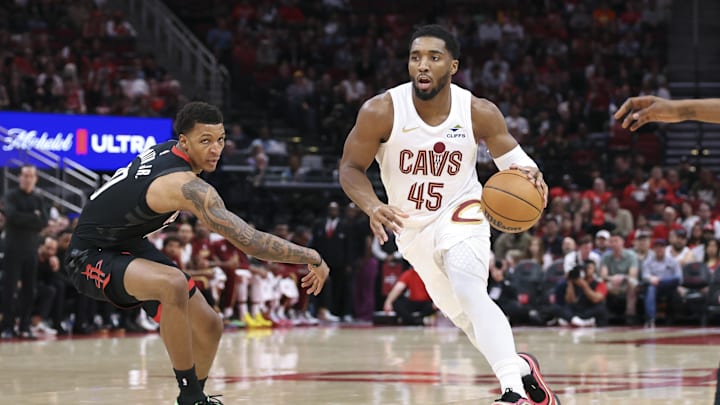 Dec 27, 2025; Houston, Texas, USA;  Cleveland Cavaliers guard Donovan Mitchell (45) drives with the ball as Houston Rockets forward Jabari Smith Jr. (10) defends during the first quarter at Toyota Center. Mandatory Credit: Troy Taormina-Imagn Images