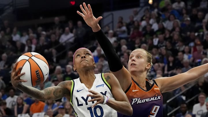 Jul 16, 2025; Minneapolis, Minnesota, USA; Minnesota Lynx guard Courtney Williams (10) goes to the basket against Phoenix Mercury guard Kitija Laksa (9) in the first quarter at Target Center. Mandatory Credit: Bruce Kluckhohn-Imagn Images