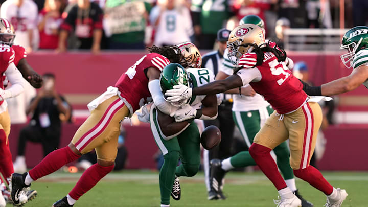 Sep 9, 2024; Santa Clara, California, USA; San Francisco 49ers linebacker Fred Warner (left) forces a fumble with linebacker De'Vondre Campbell (right) against New York Jets running back Breece Hall (20) during the first quarter at Levi's Stadium. Mandatory Credit: Darren Yamashita-Imagn Images