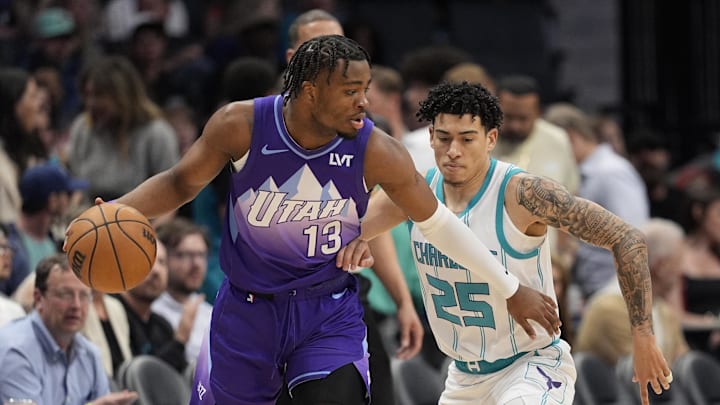 Mar 31, 2025; Charlotte, North Carolina, USA;Utah Jazz guard Isaiah Collier (13) handles the ball defended by Charlotte Hornets guard KJ Simpson (25) during the first quarter at Spectrum Center. Mandatory Credit: Jim Dedmon-Imagn Images Mar 31, 2025; Charlotte, North Carolina, USA;Utah Jazz guard Isaiah Collier (13) handles the ball defended by Charlotte Hornets guard KJ Simpson (25) during the first quarter at Spectrum Center. Mandatory Credit: Jim Dedmon-Imagn Images