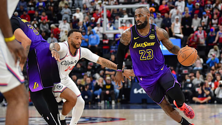 Jan 19, 2025; Inglewood, California, USA; Los Angeles Lakers forward LeBron James (23) moves the ball as forward Anthony Davis (3) provides coverage against Los Angeles Clippers guard Norman Powell (24) during the second half at Intuit Dome. Mandatory Credit: Gary A. Vasquez-Imagn Images