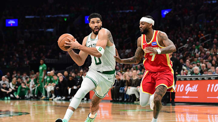 Mar 27, 2026; Boston, Massachusetts, USA; Boston Celtics forward Jayson Tatum (0) drives against Atlanta Hawks guard Nickeil Alexander-Walker (7) during the second half at TD Garden. Mandatory Credit: Bob DeChiara-Imagn Images