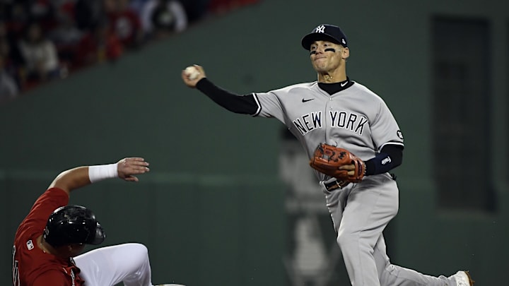 Oct 5, 2021; Boston, Massachusetts, USA; Boston Red Sox right fielder Hunter Renfroe (10) is out at second as New York Yankees shortstop Andrew Velazquez (71) throws to first for the out against catcher Kevin Plawecki (25) during the fourth inning of the American League Wildcard game at Fenway Park. Mandatory Credit: Bob DeChiara-Imagn Images