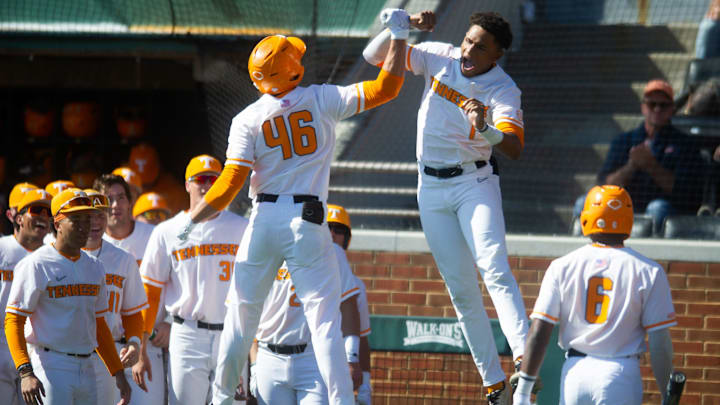 Tennessee's Dylan Dreiling (46) celebrates with teammate Christian Moore (1) after hitting a solo