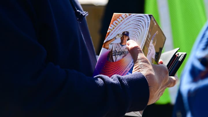 Apr 2, 2025; Los Angeles, California, USA; Spectators receive Shohei Ohtani bobblehead before the Los Angeles Dodgers play against the Atlanta Braves at Dodger Stadium. Mandatory Credit: Gary A. Vasquez-Imagn Images