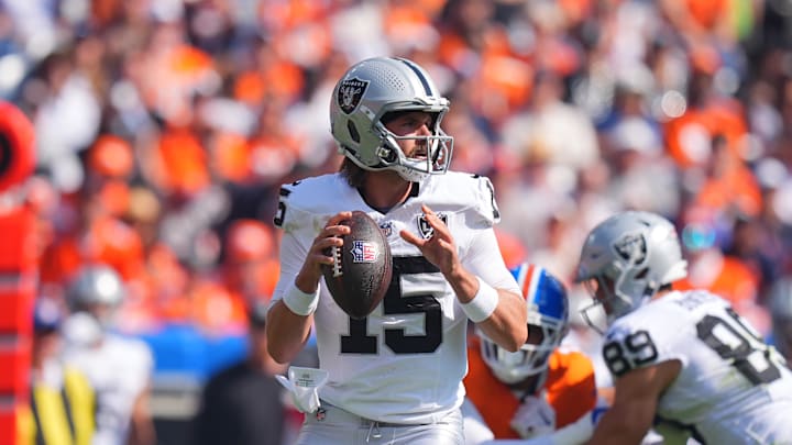 Oct 6, 2024; Denver, Colorado, USA; Las Vegas Raiders quarterback Gardner Minshew (15) prepares to pass in the first quarter against the Denver Broncos at Empower Field at Mile High. Mandatory Credit: Ron Chenoy-Imagn Images