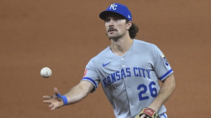 Sep 10, 2025; Cleveland, Ohio, USA; Kansas City Royals second baseman Adam Frazier (26) tosses the ball to first base in the seventh inning against the Cleveland Guardians at Progressive Field. Mandatory Credit: David Richard-Imagn Images