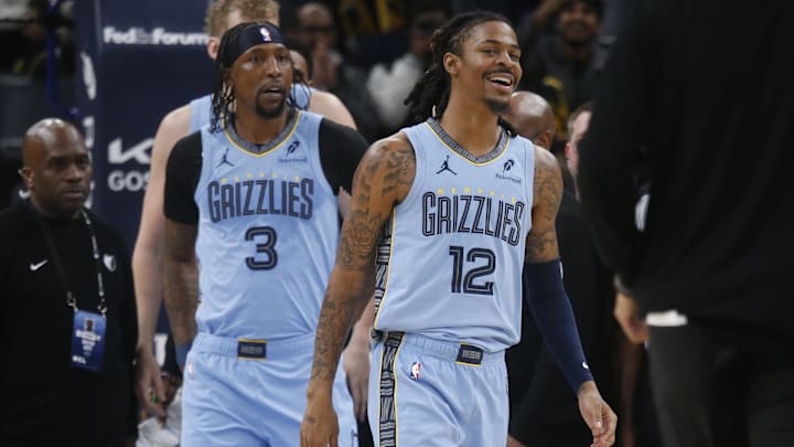 Jan 21, 2026; Memphis, Tennessee, USA; Memphis Grizzlies guard Ja Morant (12) reacts after having to be separated from Atlanta Hawks forward Mouhamed Gueye (18) after an altercation during the second quarter at FedExForum. Mandatory Credit: Petre Thomas-Imagn Images