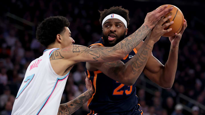 Mar 17, 2025; New York, New York, USA; New York Knicks center Mitchell Robinson (23) drives to the basket against Miami Heat center Kel'el Ware (7) during the first quarter at Madison Square Garden. Mandatory Credit: Brad Penner-Imagn Images