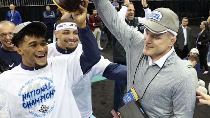 Penn State wrestling coach Cael Sanderson celebrates with Carter Starocci and the Nittany Lions after winning the team title at the 2024 NCAA Wrestling Championships.