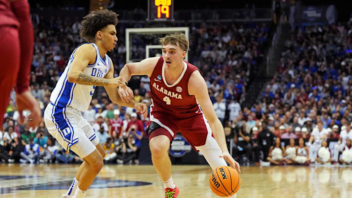 Mar 29, 2025; Newark, NJ, USA; Alabama Crimson Tide forward Grant Nelson (4) drives to the basket against Duke Blue Devils guard Tyrese Proctor (5) during the first half in the East Regional final of the 2025 NCAA tournament at Prudential Center. Mandatory Credit: Robert Deutsch-Imagn Images